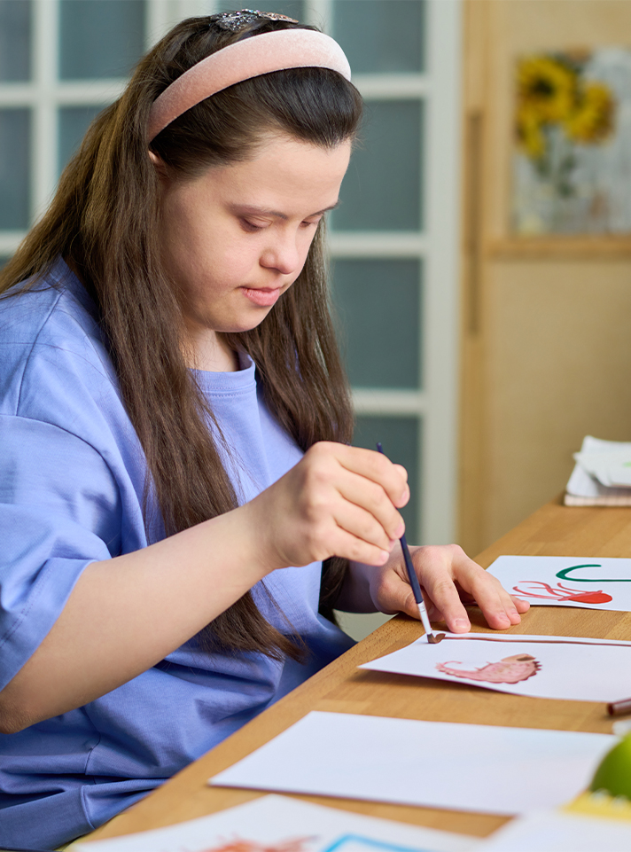 niña-sindrome-de-down-pintando Programa Discapacidad